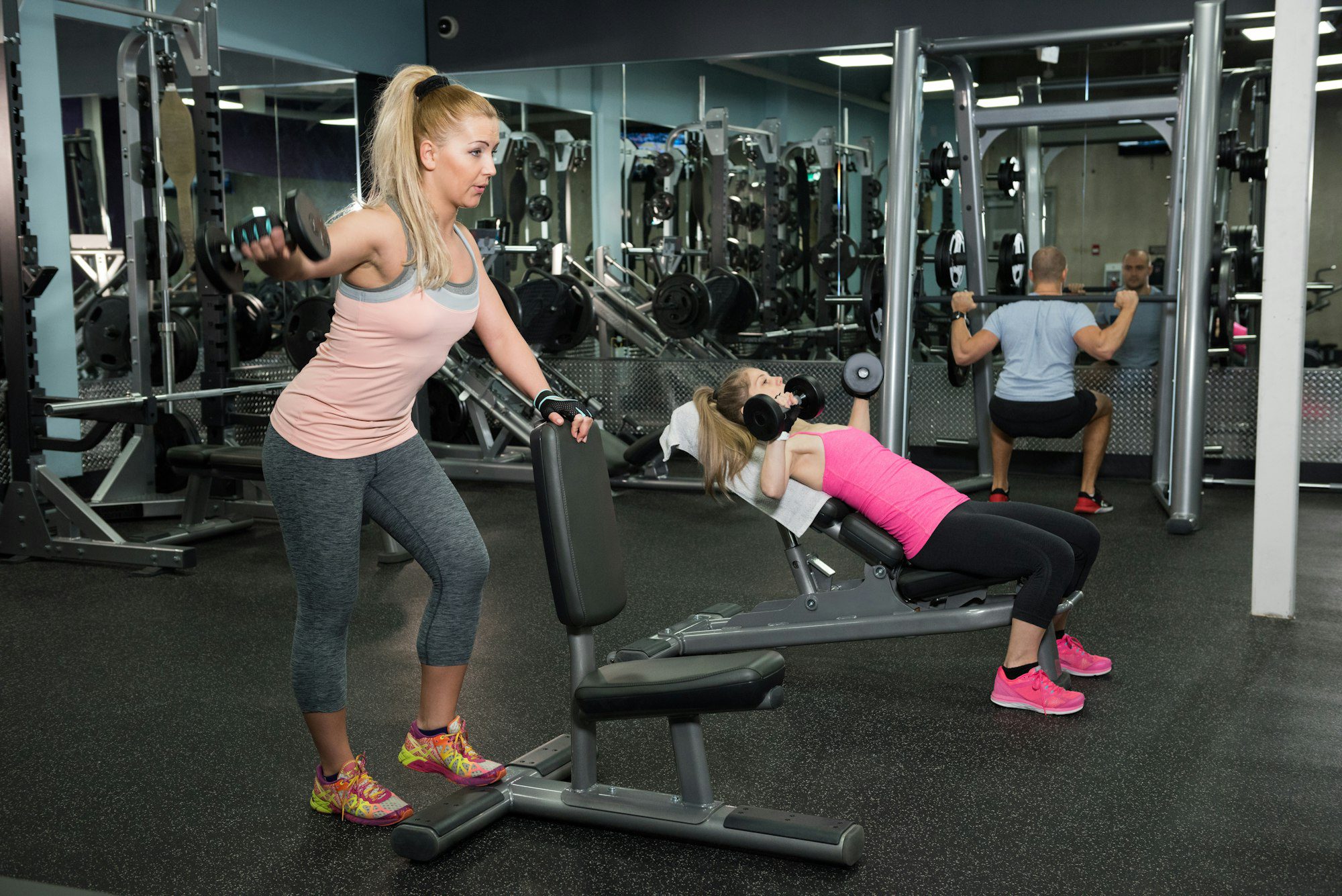 Man and woman exercising in gym